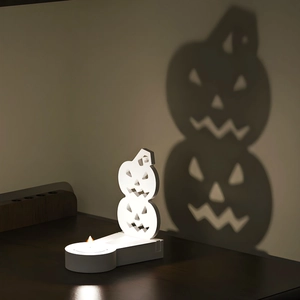 Atmospheric Halloween Jack-o'-lantern candle holder casting spooky pumpkin shadows on wall