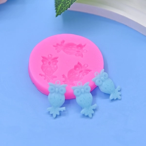 Pink owl silicone mold for DIY baking, cakes, and pendants on a blue background