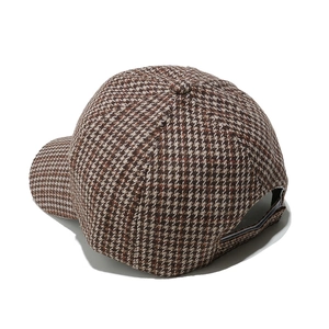 Detail view of adjustable back strap and houndstooth fabric texture on baseball cap