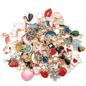 Assorted colorful enamel metal charms with stars, moons, and fruit shapes for DIY jewelry