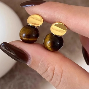 Macro shot showing the 18k gold plated stud and polished tiger eye stone bead detail