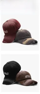 Detailed view of frayed distressed edges and vintage 3D letter embroidery on cotton cap