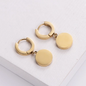 Elegant 18k gold plated titanium steel Roman numeral hoop earrings for women on a white base