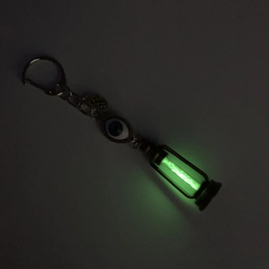 Luminous green glow of retro kerosene lamp pendant with bronze finish and evil eye detail