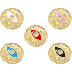 Detailed view of colorful enamel evil eye charms with gold textured finish and crystals