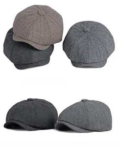 Detail shot of classic herringbone fabric texture on retro newsboy caps in multiple colors