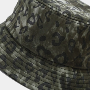 Detailed view of the dark green leopard print cotton twill fabric on a bucket hat