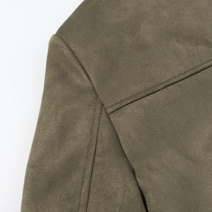 Macro shot of faux suede shoulder stitching and brushed fabric texture on army green blazer