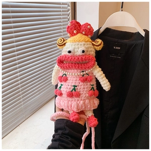 Detailed crochet sausage mouth doll bag featuring cherry pattern dress and pearl necklace