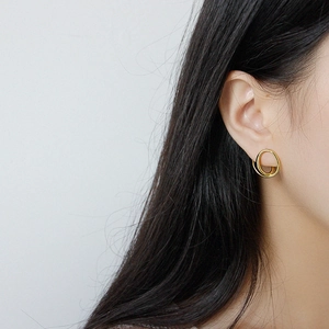 Minimalist S925 sterling silver golden earrings featuring a twisted double ring design