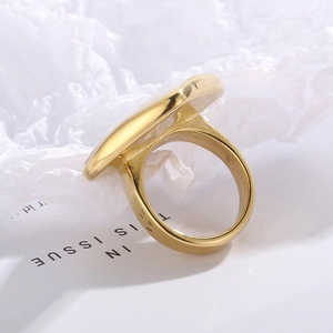 Detailed close-up of the smooth golden stainless steel ring band with mirror finish