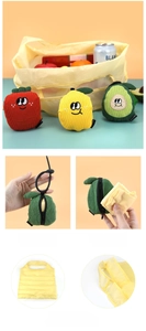 Detail showing foldable fruit-shaped shopping bag being tucked into a cute plush pendant