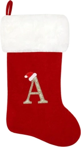Close-up of red velvet Christmas stocking with gold embroidered letter A and plush cuff