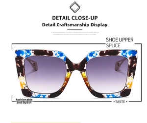 Detail close-up of oversized square sunglasses with colorful splash tortoise texture