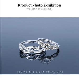 Detail of silver couple rings with infinity weave and three sparkling zircon stones