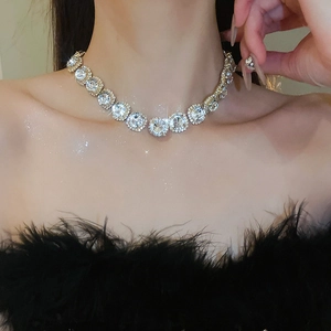 Close-up of sparkling silver cubic zirconia flower necklace worn by a model