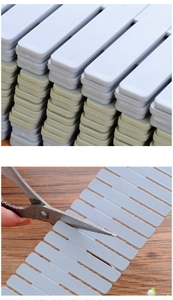 Detail of adjustable DIY drawer dividers being cut with scissors for a custom size fit