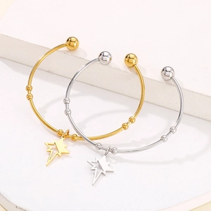 Minimalist gold and silver star bangles with octagonal pendants on white background