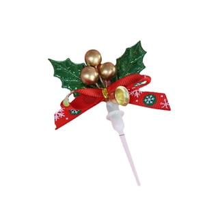 Christmas cake topper with green glitter holly leaves, gold berries and red ribbon bow
