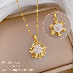 Detail view of gold snowflake necklace with dimensions 1.5x2.4cm and 40+5cm chain length