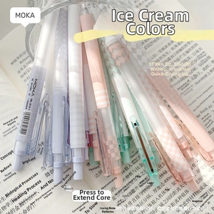 Detailed view of assorted pastel gel pens in a glass jar over an open notebook