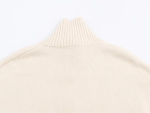 Détail de la maille douce beige et du col montant de ce cardigan élégant pour femme