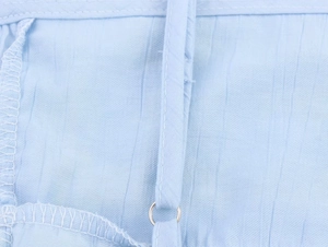 Detail of light blue lace top showing adjustable shoulder straps and silver metal rings