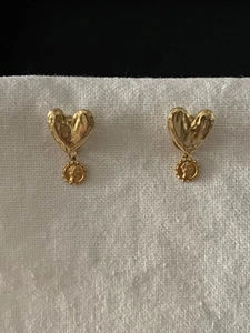 Detail of 925 sterling silver heart and coin earrings with vintage gold finish
