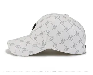 Detail view of white baseball cap with gray letter pattern and black side emblem