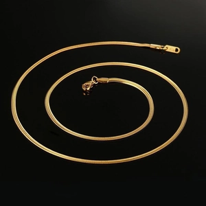 Macro detail of 3mm gold-plated snake chain necklace with K18 engraving and lobster clasp