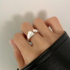 Close-up of minimalist 925 sterling silver ring with irregular organic water drop design