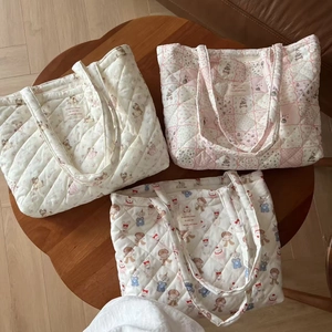 Detailed set of three quilted tote bags featuring floral patterns and animal prints