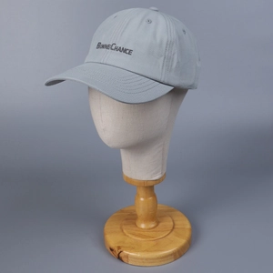 Detailed view of the black letter embroidery on light gray soft cotton baseball cap