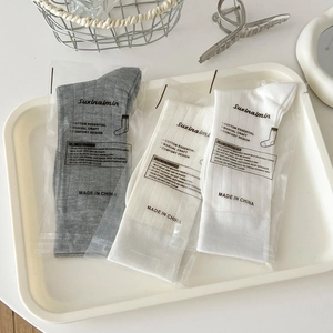 Minimalist cotton knit crew socks in grey and white colors with a soft ballet style finish