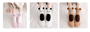 Detail of coral fleece winter socks featuring 3D cartoon animal ears and soft texture