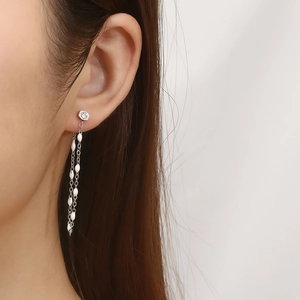 Elegant silver tassel earrings with zircon studs and teardrop beads on a model