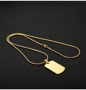 Detailed close-up of a polished gold stainless steel rectangle pendant with snake chain