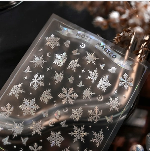 Macro detail of laser iridescent snowflake nail stickers with holographic stars and moons