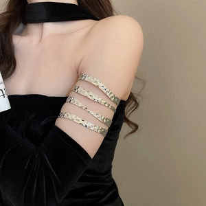 Close-up of hammered metal arm cuff showing the textured surface and multi-layer design