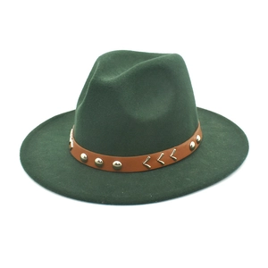 Detail of dark green wool fedora hat with brown leather band and gold rivet accents