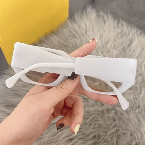Detail view of stylish white rectangular thick frame sunglasses with dark tinted lenses
