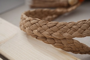 Close-up of the natural woven texture and brown straw fiber on this large tote bag
