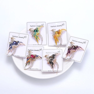 Detail of colorful phoenix brooches with enamel and rhinestones on display cards