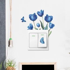 Detailed view of blue tulip flower and butterfly wall stickers on a white double switch