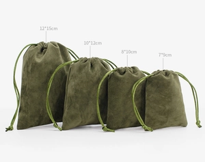 Four different sizes of green velvet drawstring jewelry pouches on a white background