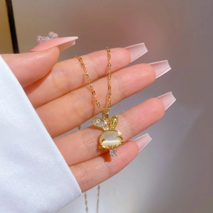Golden bunny necklace with cat eye stone and sparkling cubic zirconia crystal detail