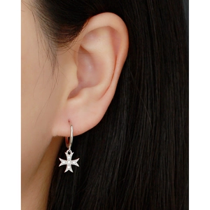 Close-up of S925 sterling silver cross earring with micro-inlaid zircon on model