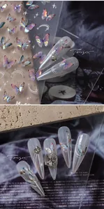 Macro detail of 5D laser butterfly nail art stickers with iridescent gold finish