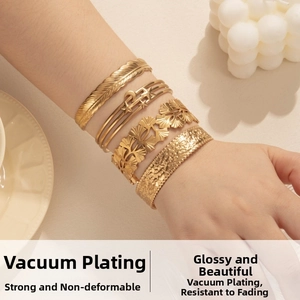 Set of four gold-plated stainless steel bangles featuring feather and celestial patterns