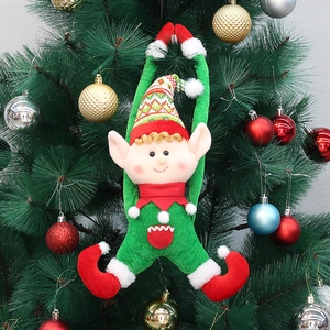 Christmas elf plush doll hanging ornament on a Christmas tree with red and green fabric